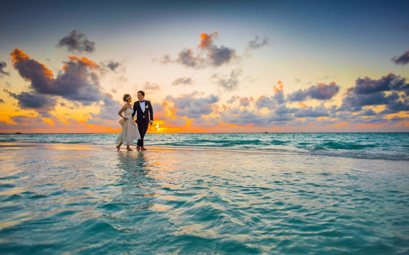 Romantic beach wedding couple at sunset for AI photo editing